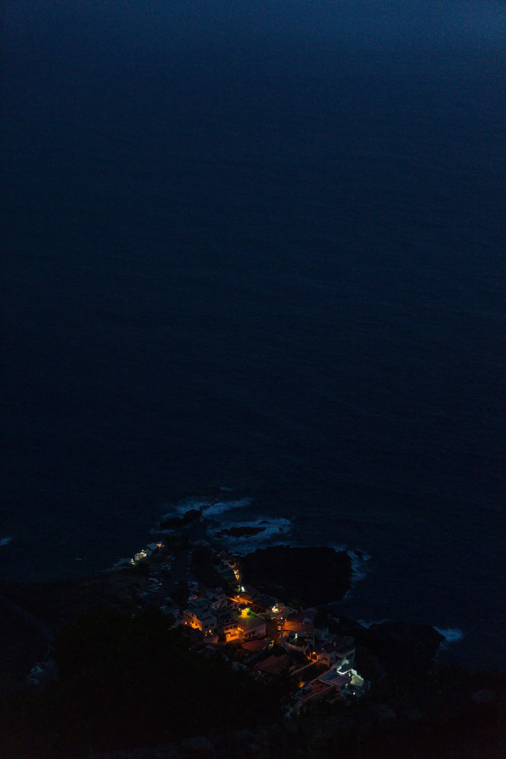 still photo of small village next to the sea by night