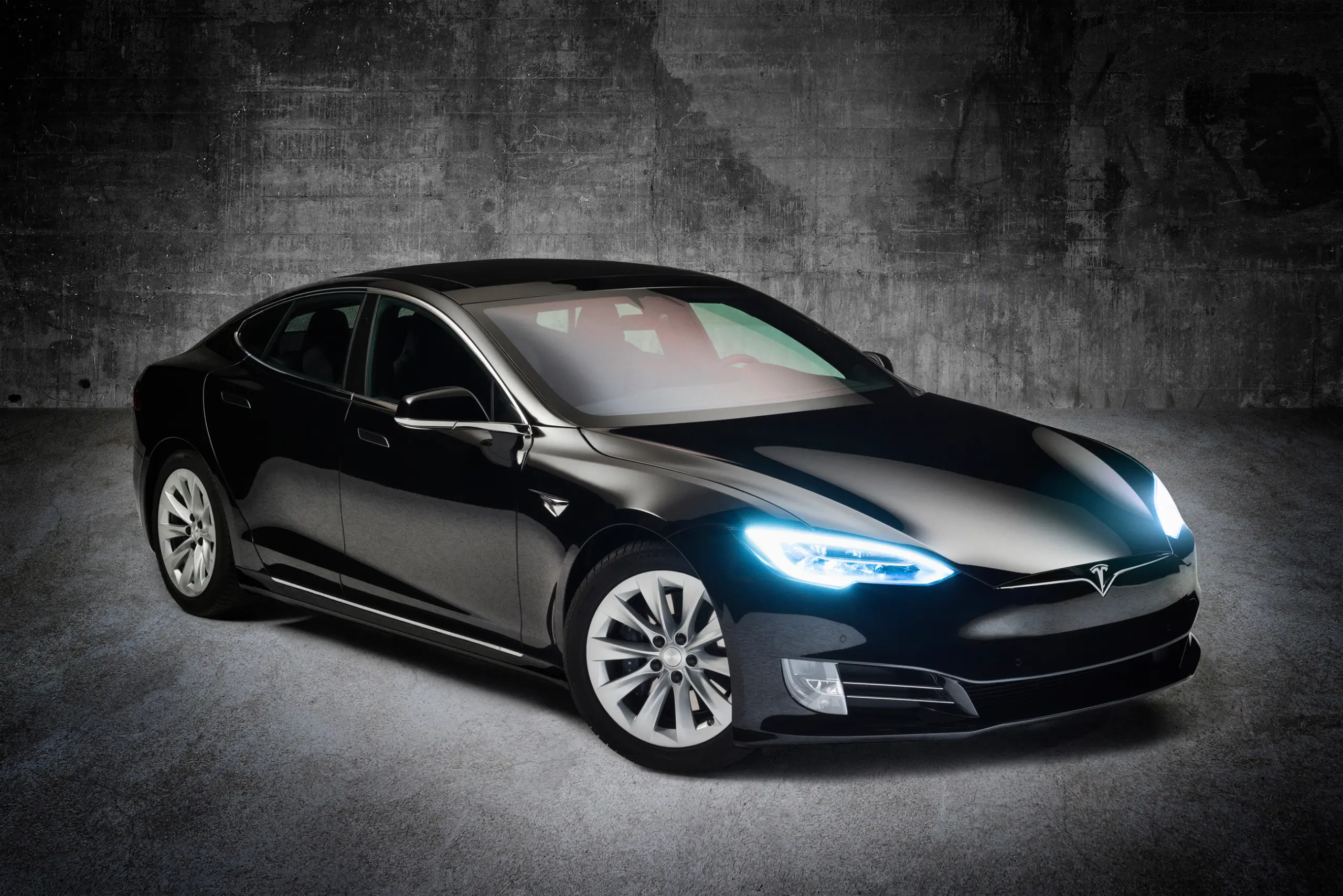 studio photo of a car, tesla model s in black in front of concrete wall, car photography